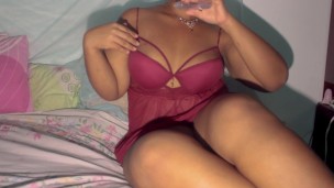 Sexy ebony in red lingerie playing with oiled boobs
