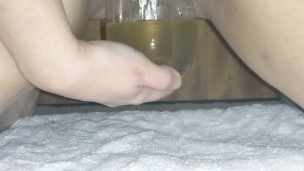 Desperately pissing in glass