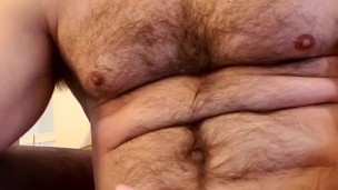 Muscle bear flexes and plays with nipples until he unloads!