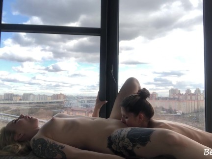 Lesbians are making love on a balcony