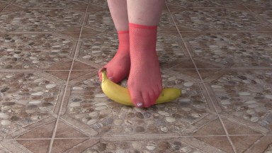 Fat legs in socks ruthlessly trample banana. Crush Fetish, foot fetish.