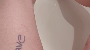 Trans boy rubbing and pissing in the bathtub