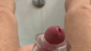 Playing with toy and jerking in bath. 