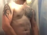 Muscular young man Stroking off in the shower