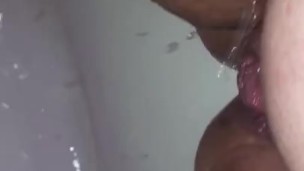 Playing with my long labia in the shower water jet 