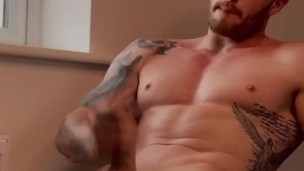 Hot guy wanks in front of the window 