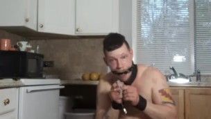  Male sub mops the dirty floor like a dog in tight restraints and chastity