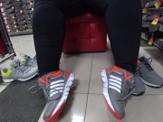Foot fetish in a public shoe store. Fat legs try on sneakers. 10/16
