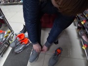 Foot fetish in a public shoe store. Fat legs try on sneakers. 12/16