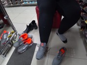 Foot fetish in a public shoe store. Fat legs try on sneakers. 13/16