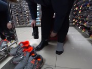 Foot fetish in a public shoe store. Fat legs try on sneakers. 16/16
