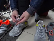 Foot fetish in a public shoe store. Fat legs try on sneakers. 2/16