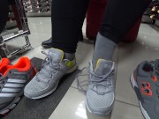 Foot fetish in a public shoe store. Fat legs try on sneakers. 3/16
