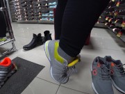 Foot fetish in a public shoe store. Fat legs try on sneakers. 5/16