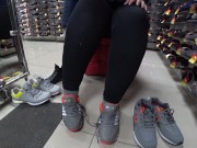 Foot fetish in a public shoe store. Fat legs try on sneakers. 7/16