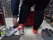 Foot fetish in a public shoe store. Fat legs try on sneakers. 9/16