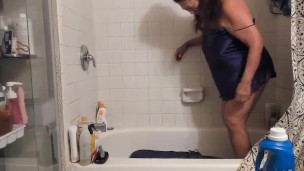 mature woman cleaning dirty cushion in bathtub with feet. Foot fetish