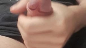 Clothed guy strokes his big dick and cums