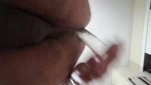 Straight Male plays with glass dildo solo