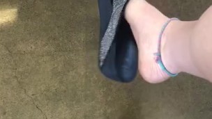 Teasing My mechanic with my stinky feet and dangling flip flop!