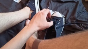 Beautiful legs in sneakers on the bed