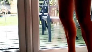 Naked in the window with ball weights 