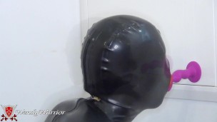 Sucking the dildo in Comdom Catsuit