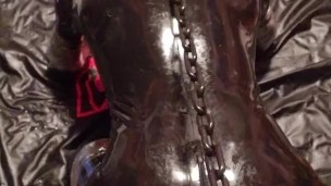 Chained to the bondage post, rubber gimp pup slave getting relentlessly fucked by the fuck machine