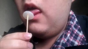 Gay teen licks and eats a lollipop made of his own cum