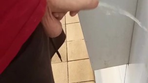 Hung lad at urinal next to me gets semi while pissing!