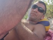 Relaxing in the shade on the beach. 1/16