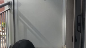 Crossdresser takes a smoke break while cuffed