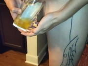Pissing in a glass in the kitchen
