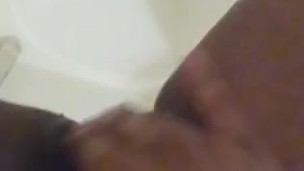 Black slut pisses in the shower