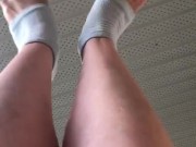Stretching my cute feet with white painted toenails 