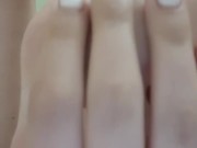 Closeup fit girl with long toes shows her slim legs and perfect feet