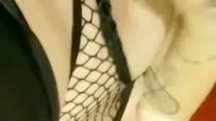 Goth girl in fishnets plays with her fat pussy