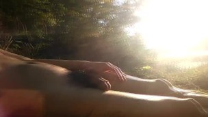 Natural teen boy lays nude by the river, wanks his hairy cock, squirts cum and relaxes during summer