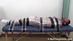 Naughty guy torments tied up friend and tickles his feet