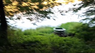 A guy in public pisses and jerks off his cock on the river bank, and a fisherman is fishing nearby