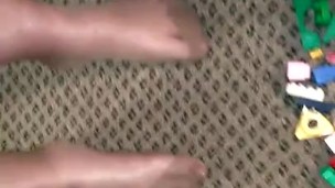 Sexy nylon feet walking on legos