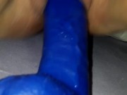 Riding big blue dildo