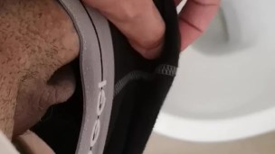 Hot and hung guy filming his dick while jerking off an cum into the toilet sink. 