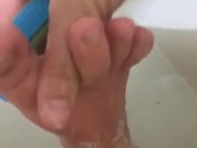 Girl washing sore feet and ankles after working long shift 10/16