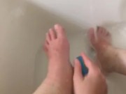 Girl washing sore feet and ankles after working long shift 13/16