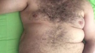 Big horny Italian hairy bearded bear wanking his cock on the bed in his underwear. Full body