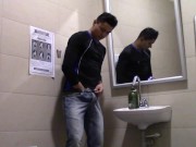 Young man enters the bathroom of a supermarket and leaves it full of milk