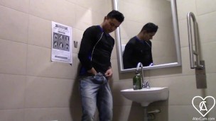 Young man enters the bathroom of a supermarket and leaves it full of milk