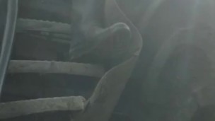 Shaved hunk in gumboots sits down and works out a hot load on tractor steps
