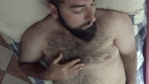 Big very horny Italian bearded bear wanking on bed playing with nipples and tickling his hairy body